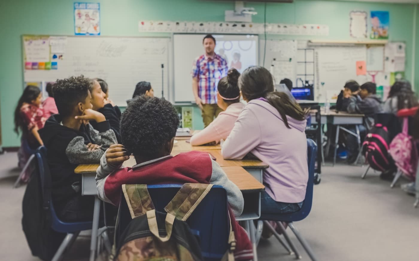 Students and their teacher during a live lesson in a real classroom